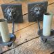 Two lion head wall sconces in tin.