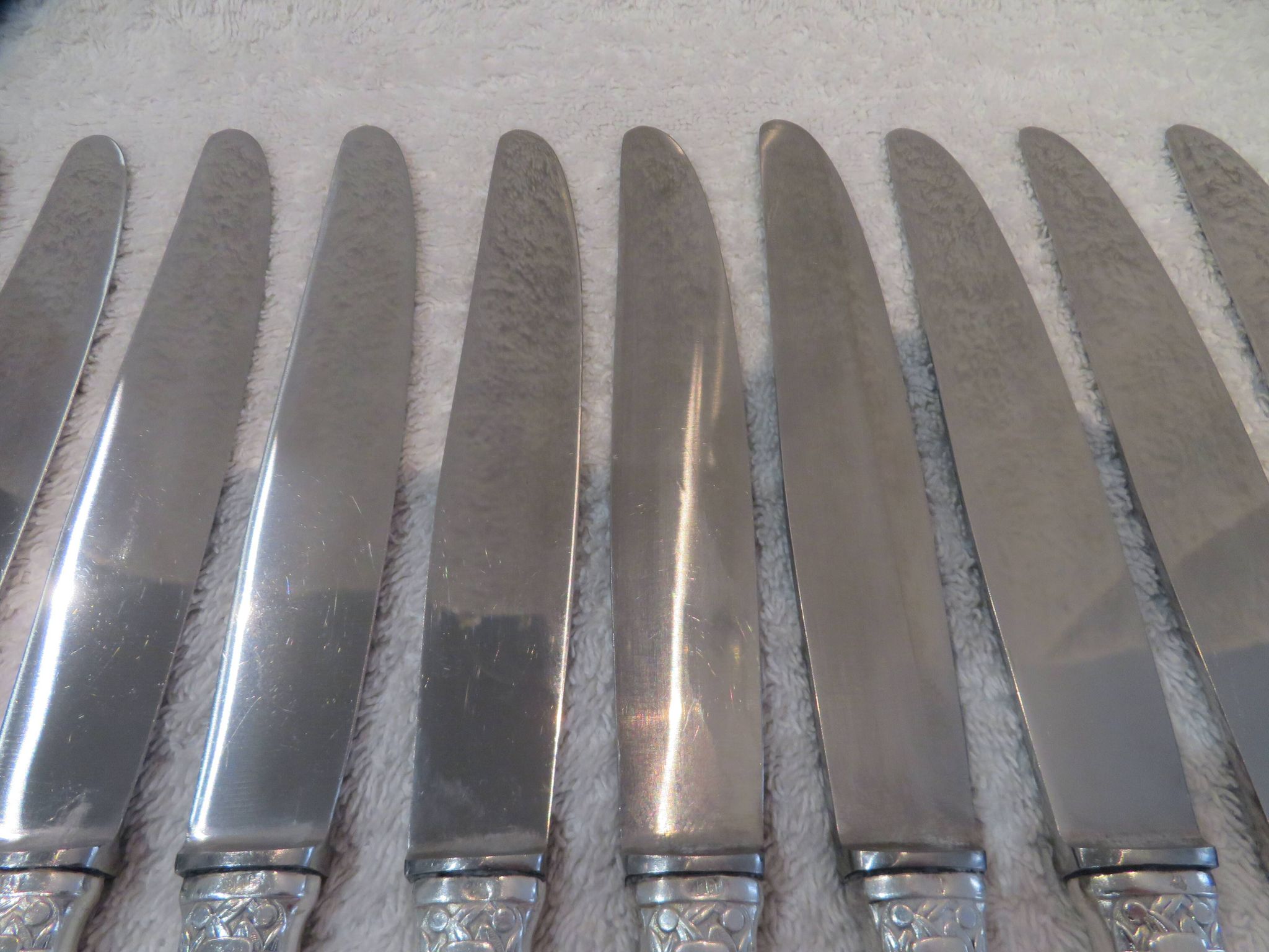 12 silver plated table knives by Argit goldsmith? Art Deco floral bands