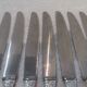 12 silver plated table knives by Argit goldsmith? Art Deco floral bands