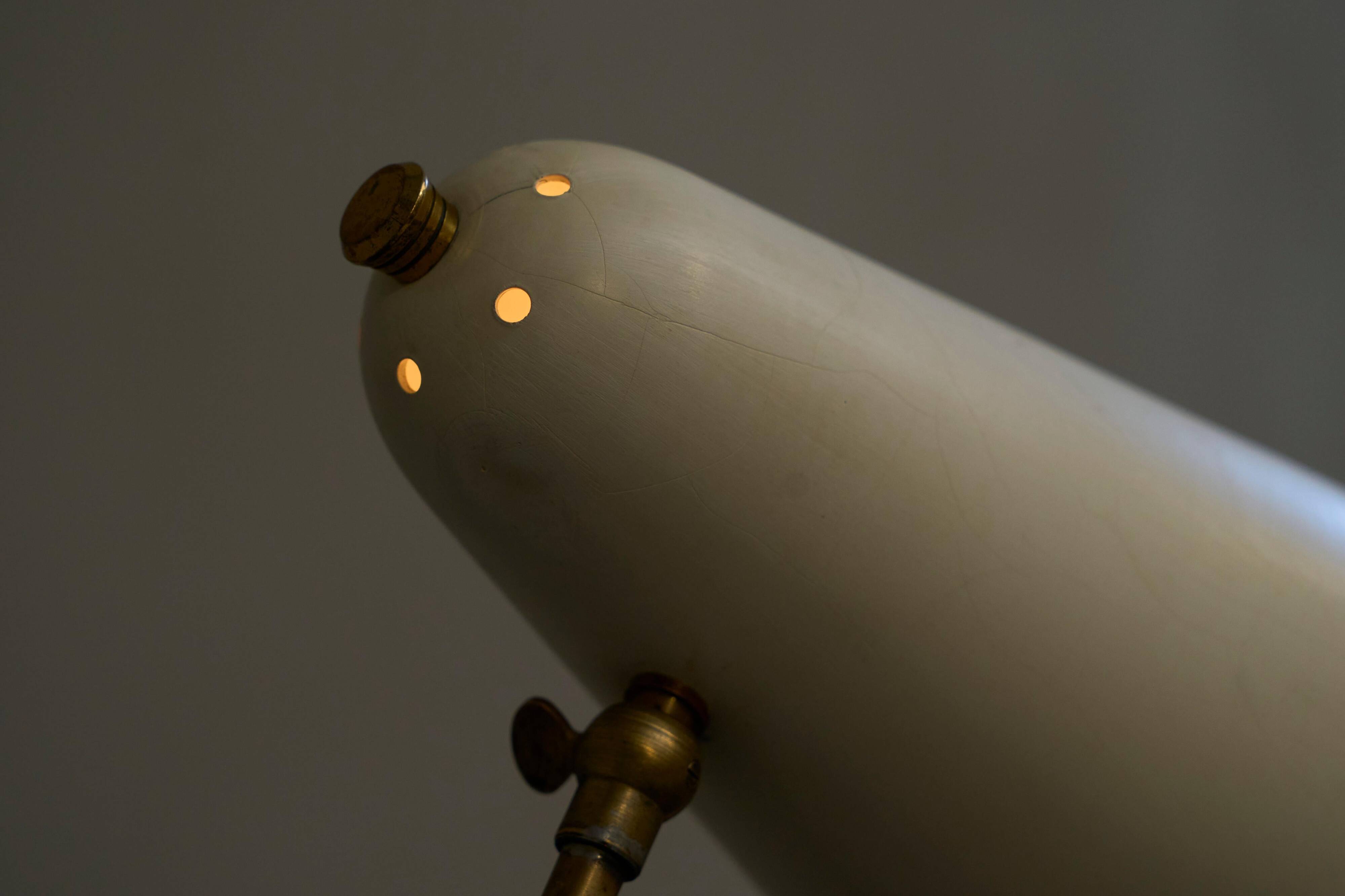 Mid Century adjustable table lamp with perforated shade from the 1950s.