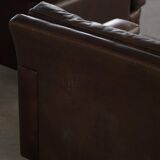 Pair of modern Danish lounge chairs in dark brown leather and rosewood, 1960s.