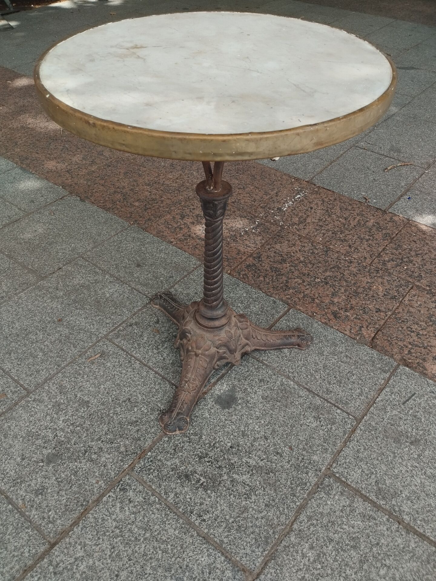 Old bistro table with marble top and cast iron base.