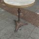 Old bistro table with marble top and cast iron base.
