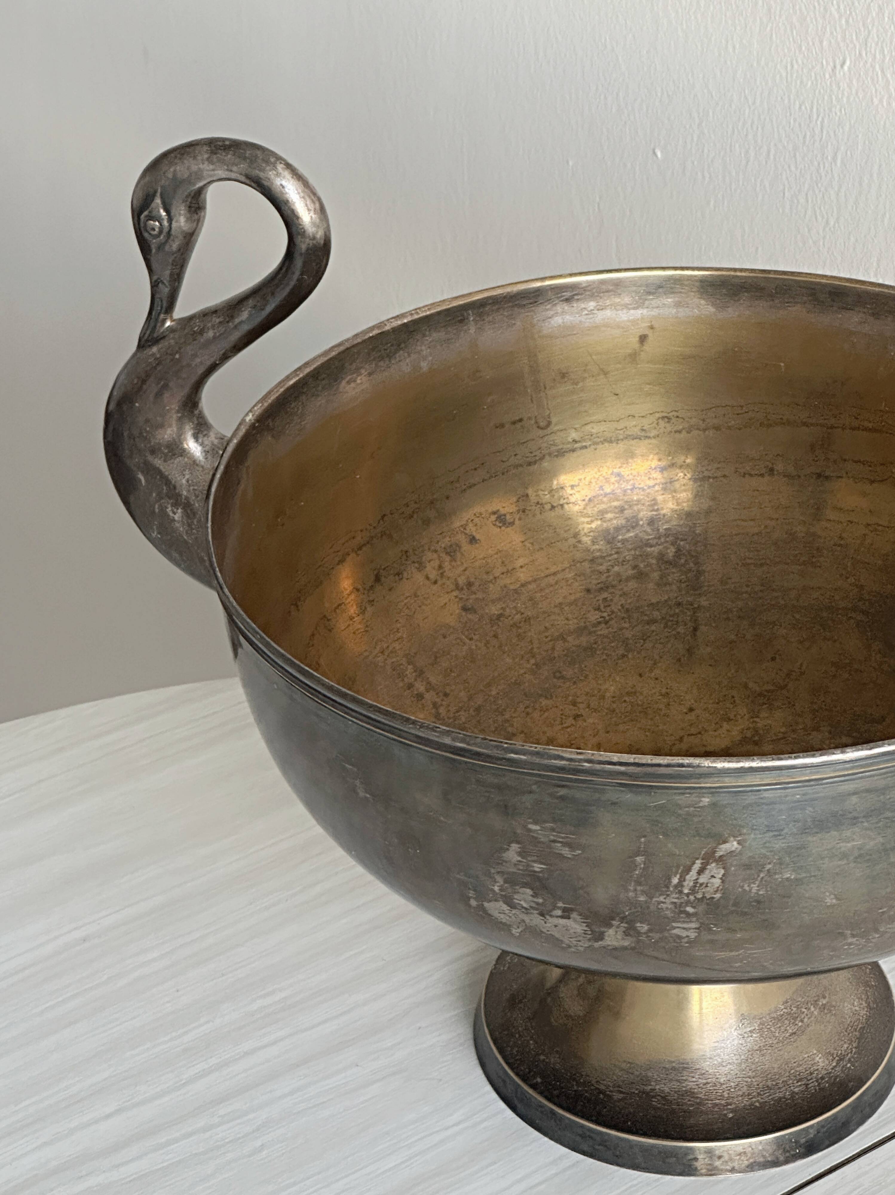 Large champagne bucket with patinated metal swan handles.