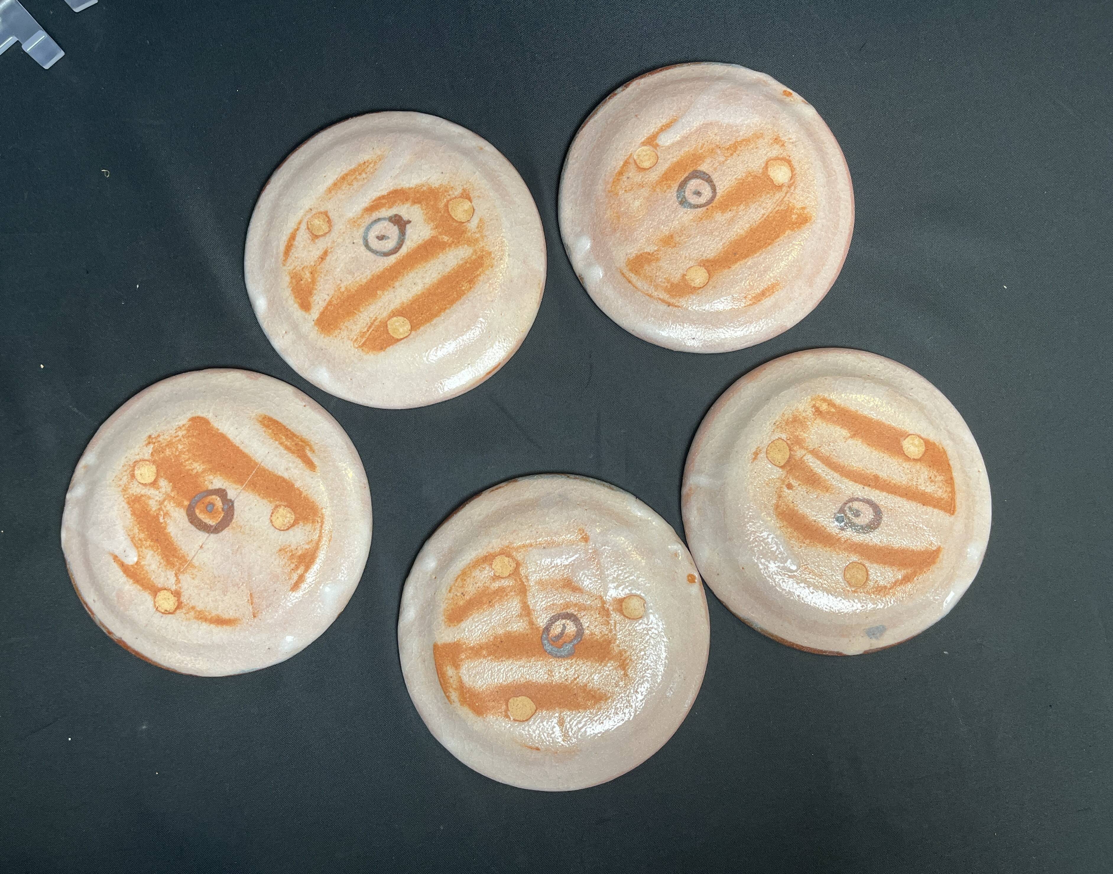 Set of five small Korean stoneware plates with pink crane, 20th century
