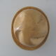 Shape of pressed plaster hat with surface and textile fiber of yellowish color,