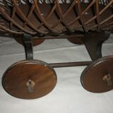 Cradle of doll in rattan on wheels