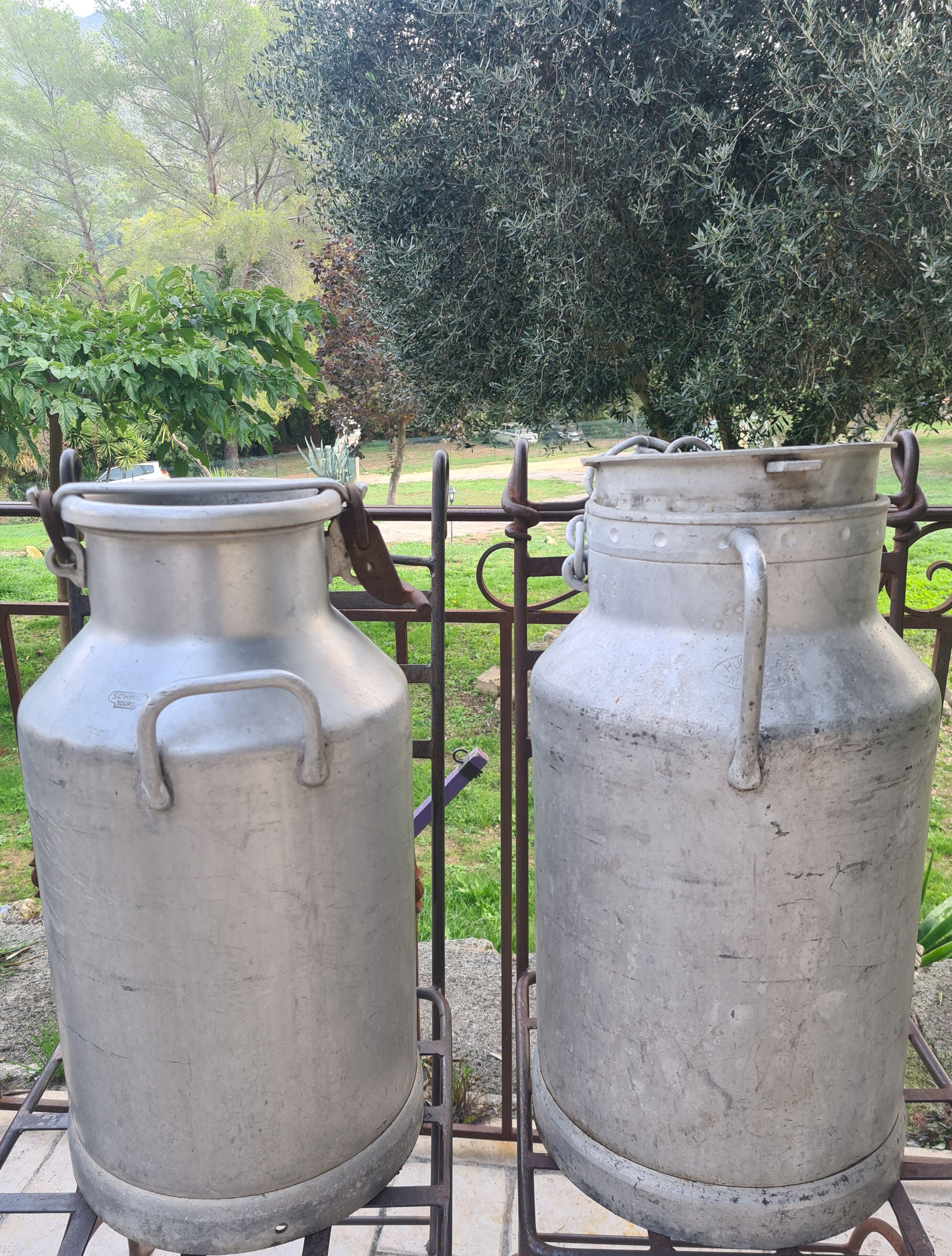 set of 2 old aluminum milk jugs
