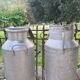 set of 2 old aluminum milk jugs
