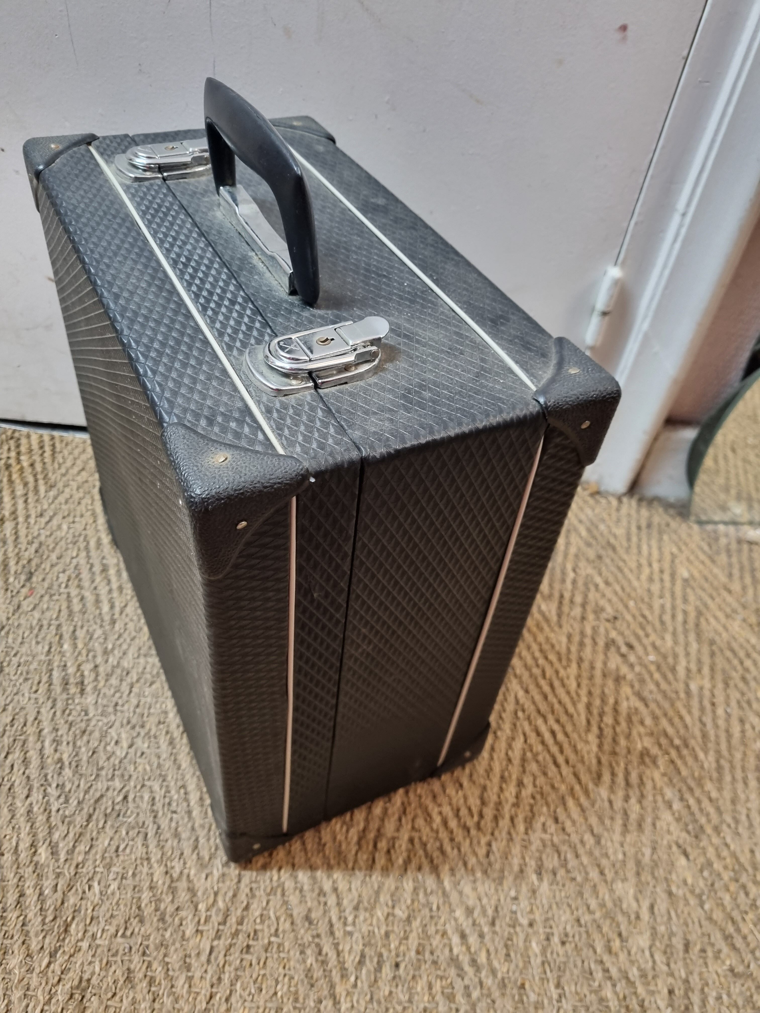Red Aidi R accordion in his suitcase