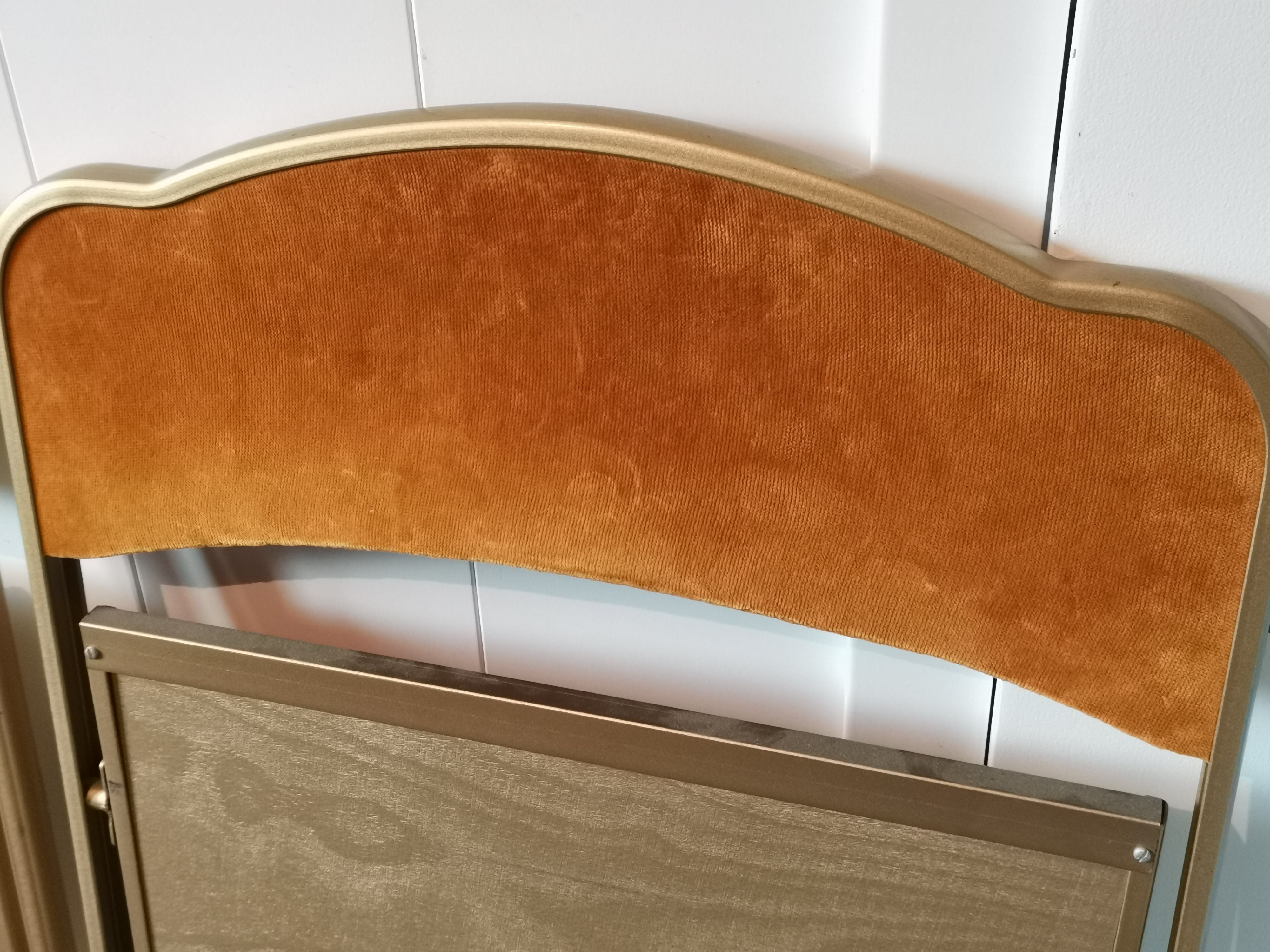 Two gold velvet folding chairs