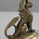 Handheld candlestick in bronze featuring a griffin, 19th-century Empire style.