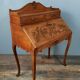 Louis XV style stepped donkey back desk in walnut in early 1900