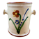 Antique ceramic pot with hand-painted floral decoration.
