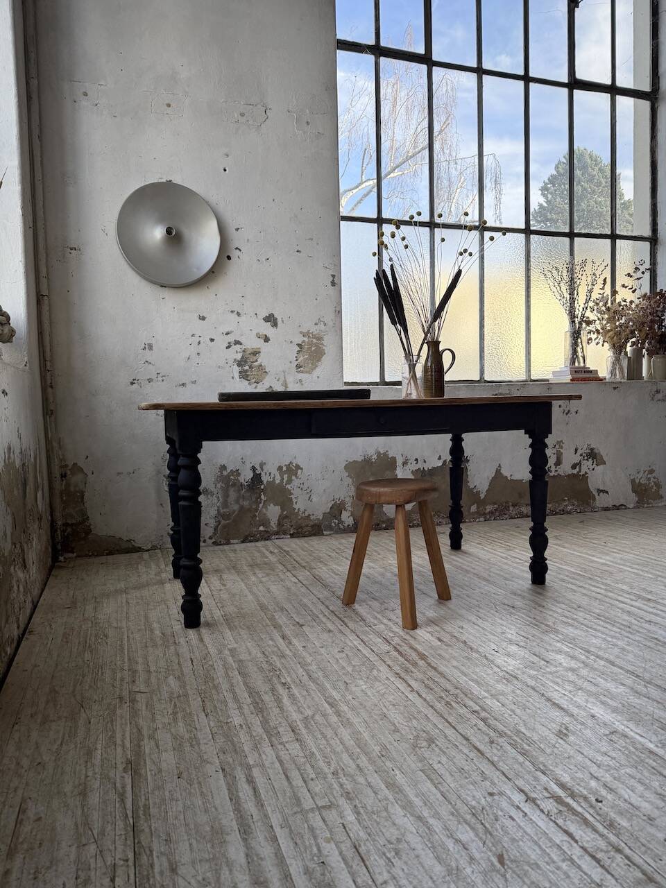Oak farmhouse table with turned black legs.