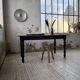 Oak farmhouse table with turned black legs.