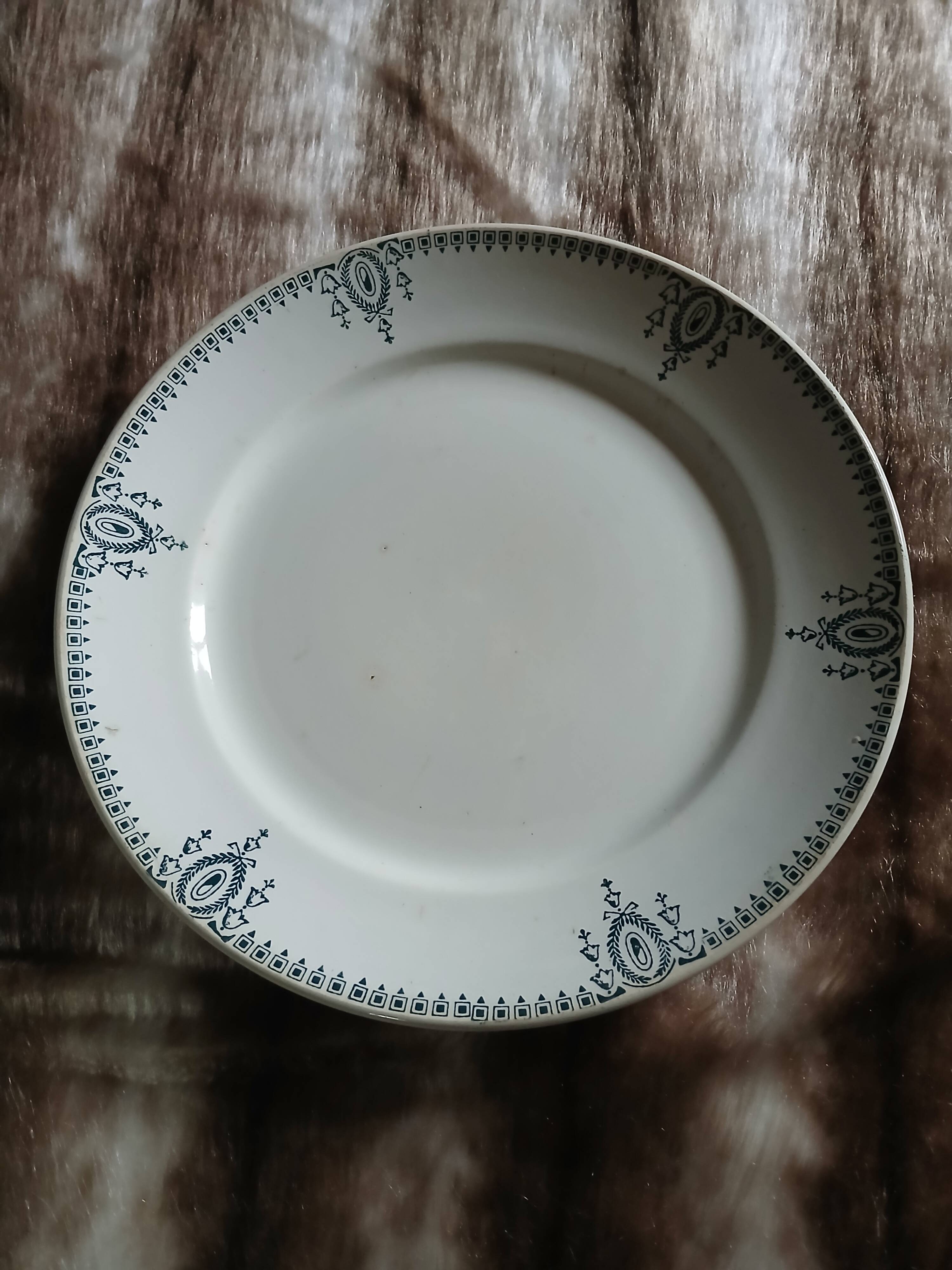 Old round plate made of ironstone