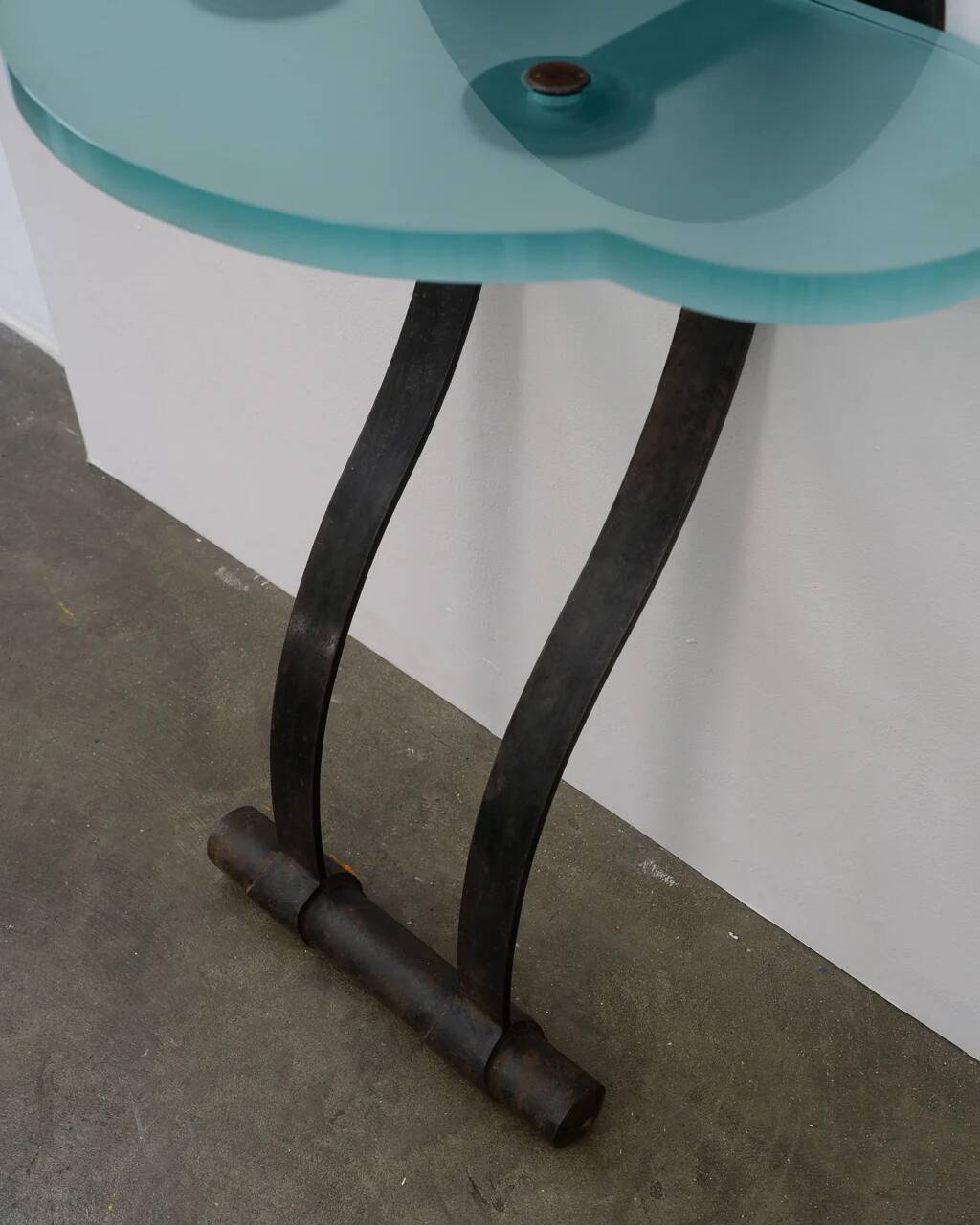 Artisanal wrought iron and cast glass leaning console table