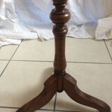 Round end table with tripod mast. 50 years. Medium oak color.
