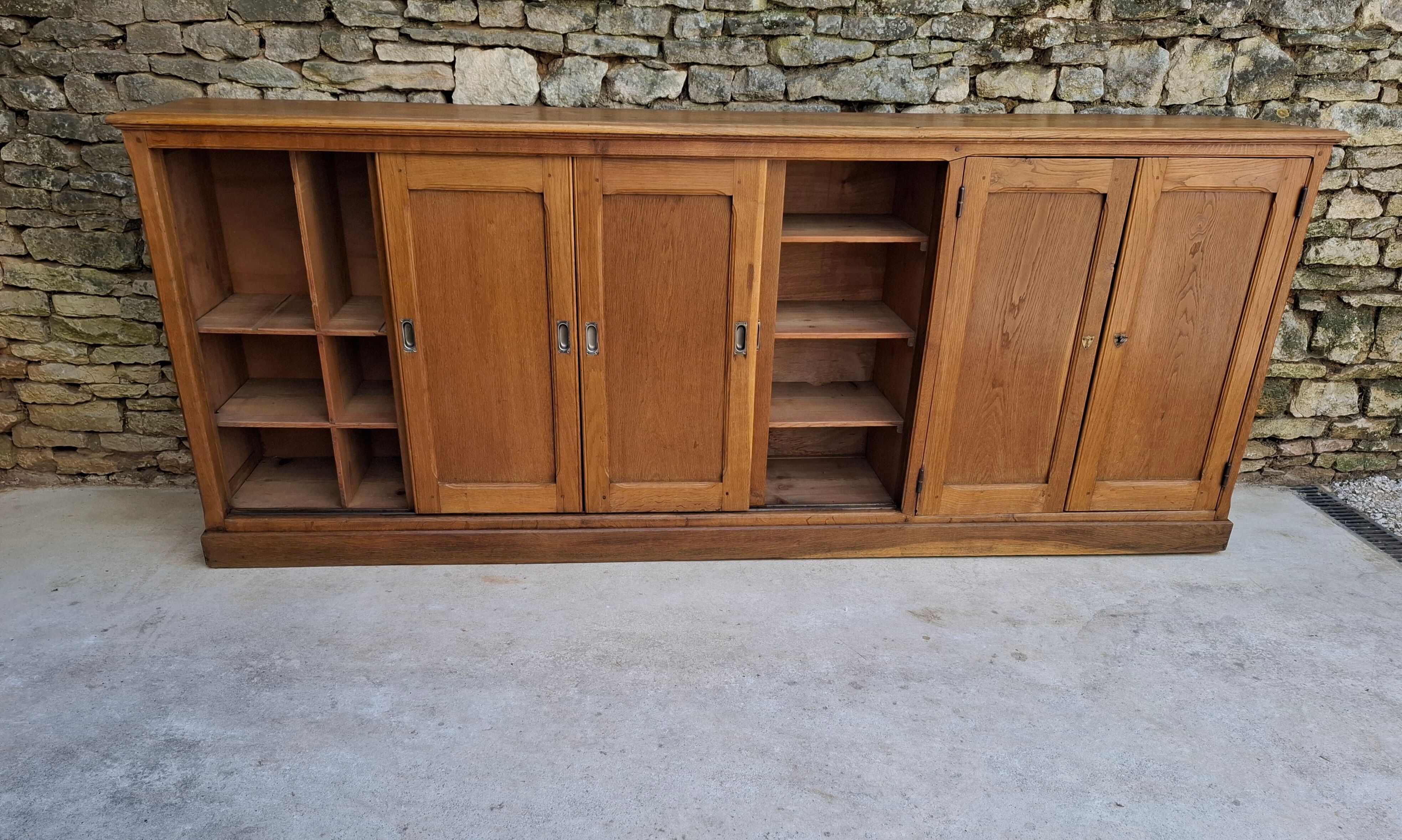 Oak workshop furniture with sliding doors.
