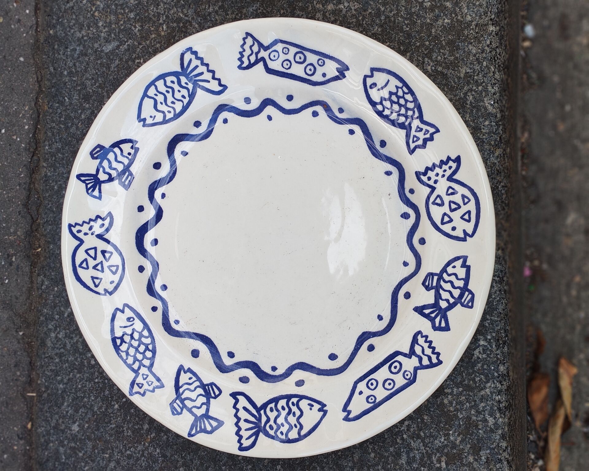 Pair of Castellania plates from Italy with blue fish decoration.