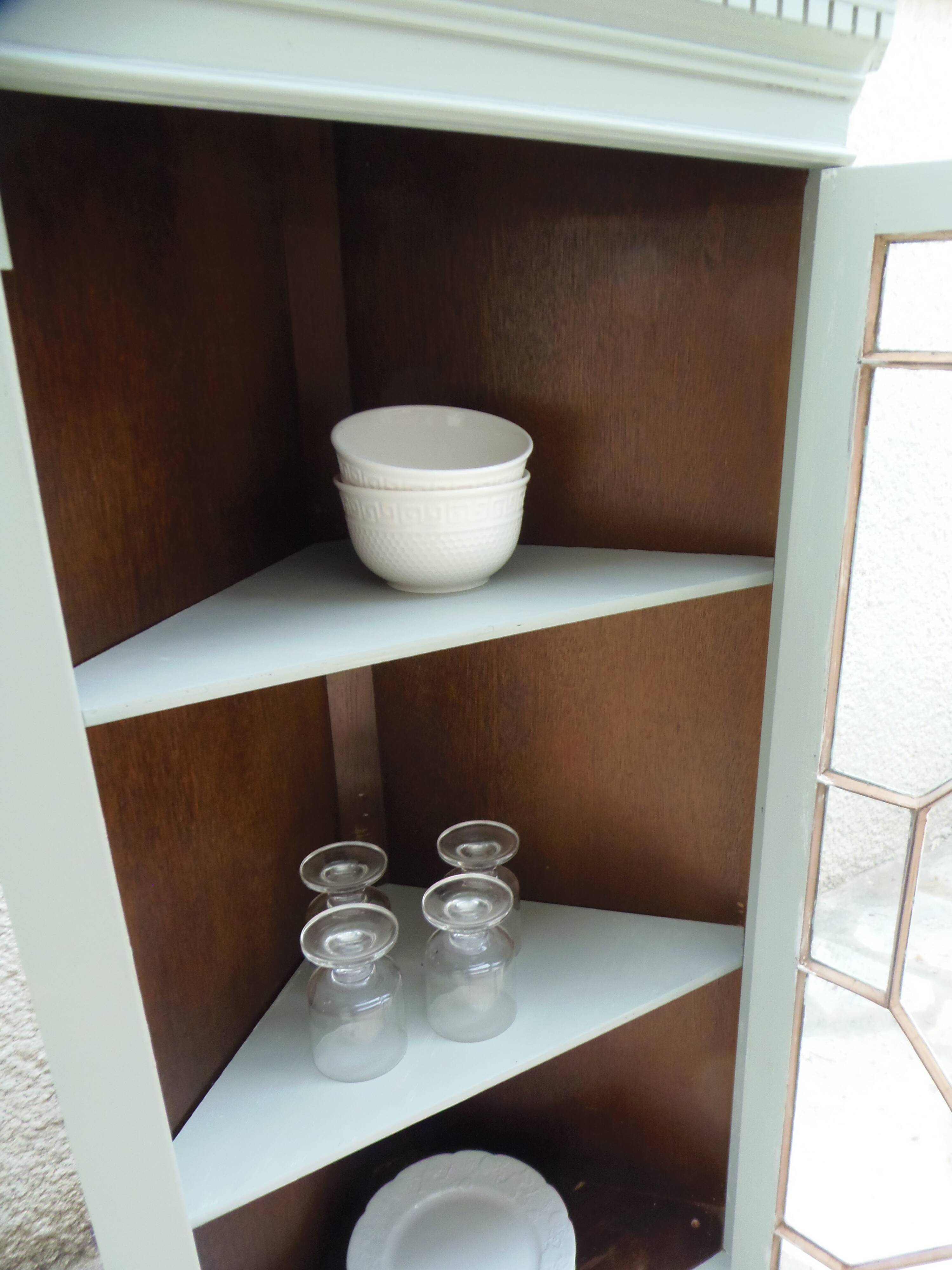 Vintage English corner display cabinet enhanced in grey-green with a wooden top.