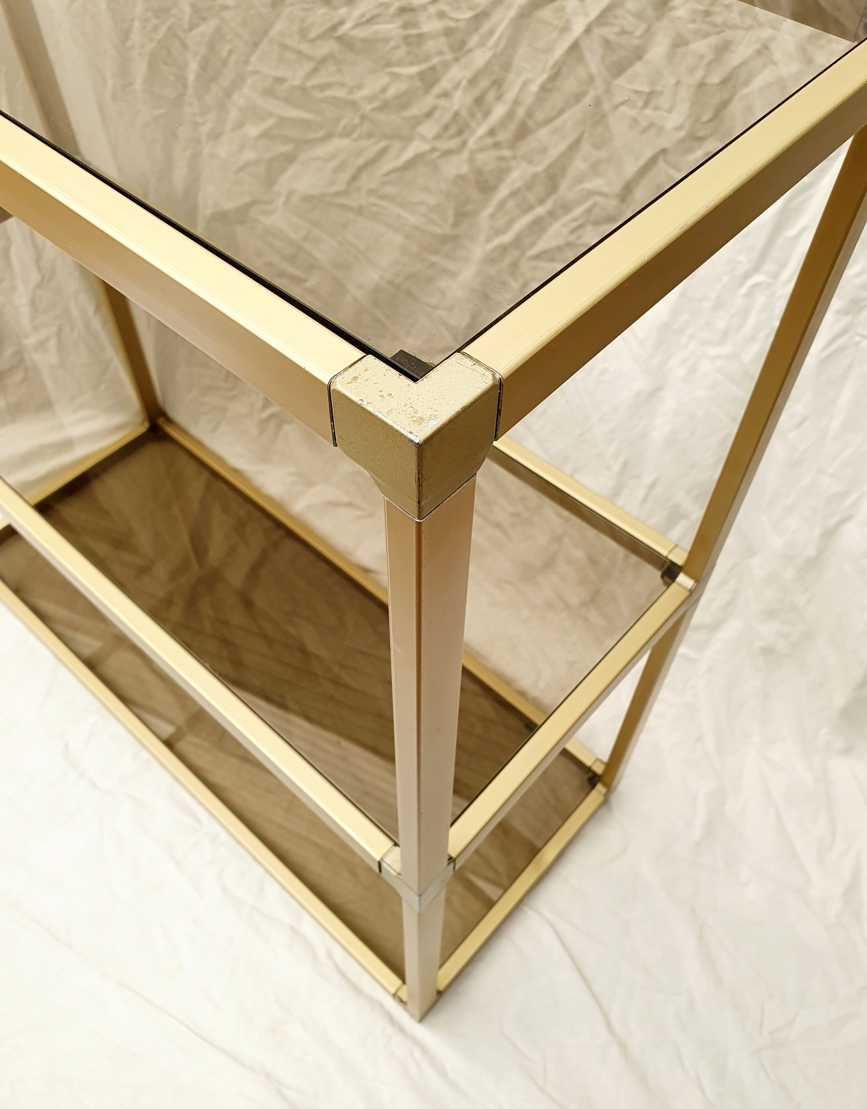 Golden metal shelf and smoked glass