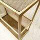 Golden metal shelf and smoked glass