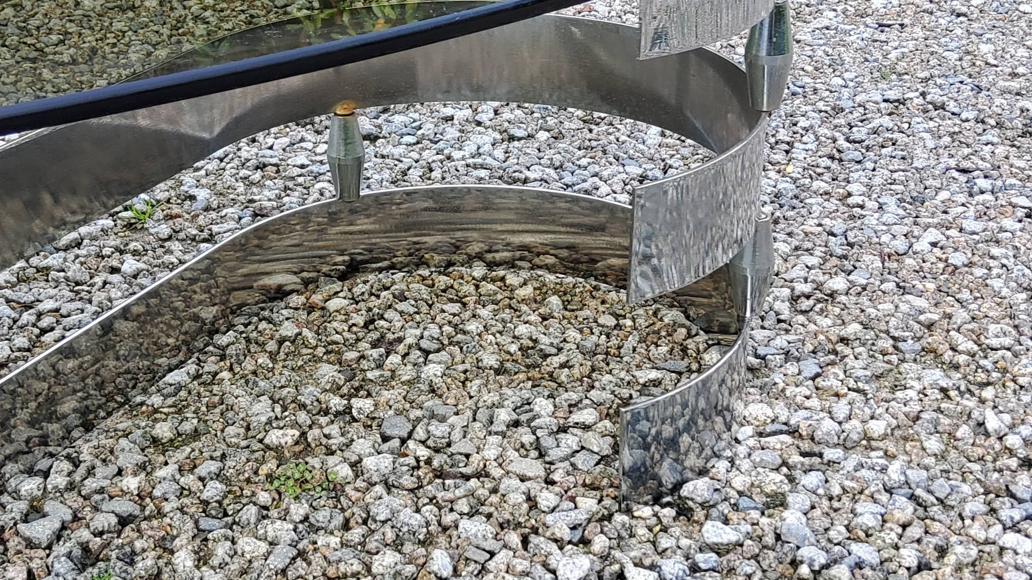 Oval coffee table of the 70s chromed metal base in s smoked glass top