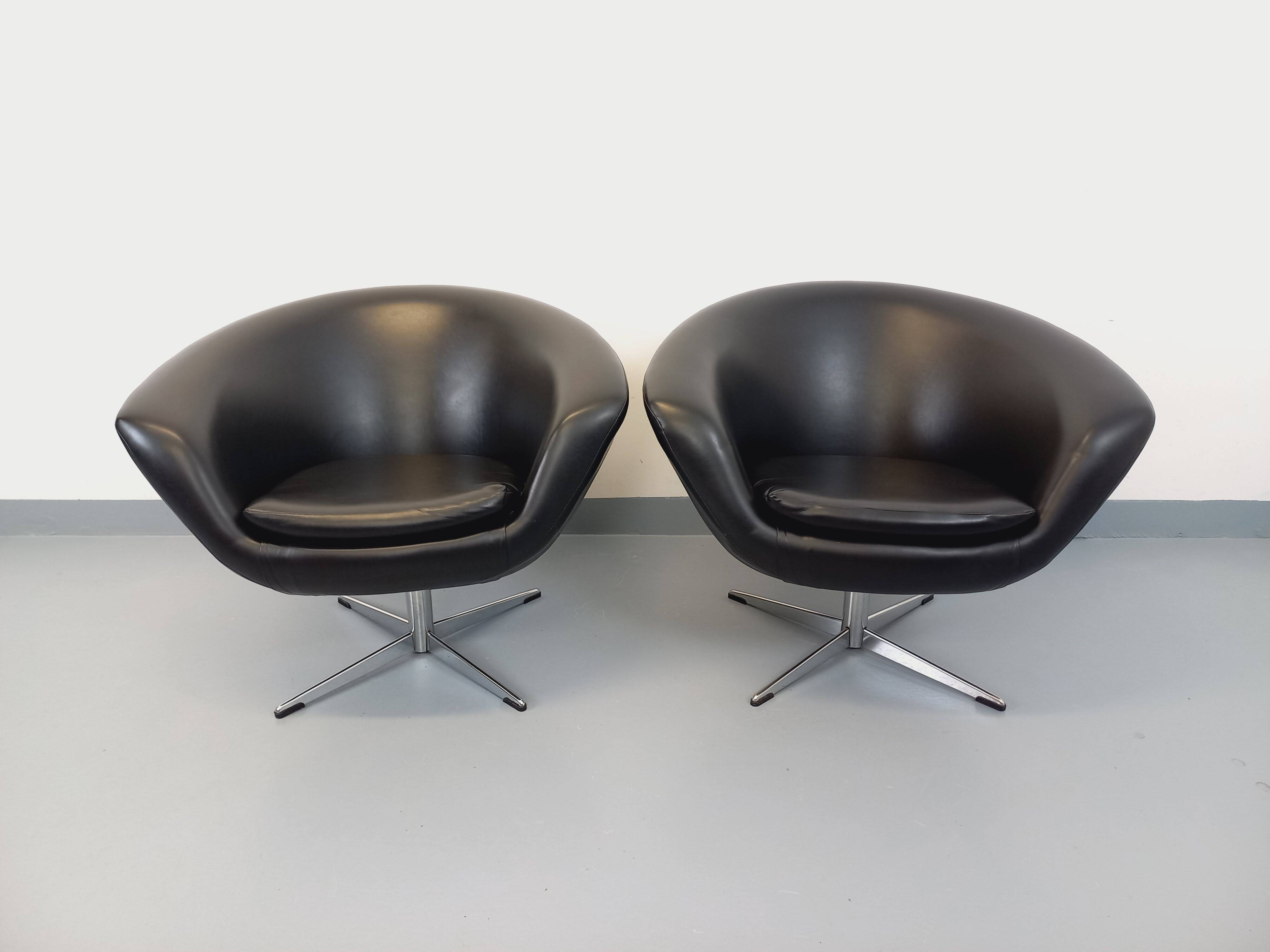 Pair of vintage Scandinavian swivel armchairs in faux leather and chrome.