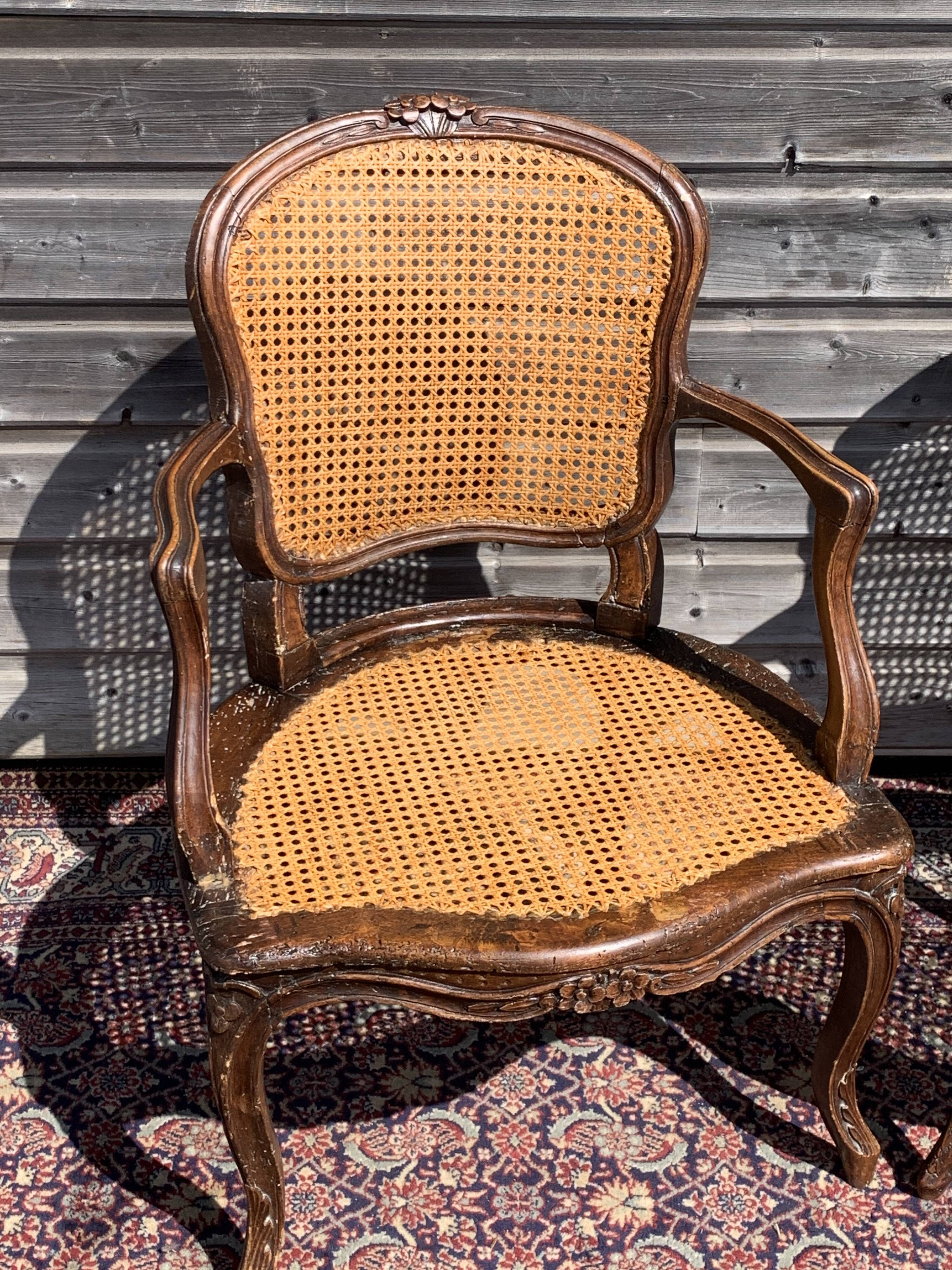 Pair of caned convertible armchairs Louis XV period