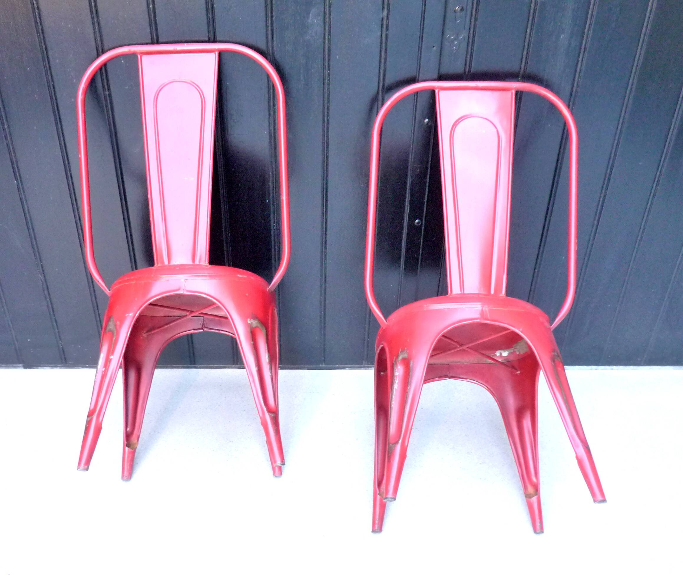 Pair of red stackable metal chairs