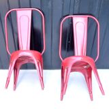 Pair of red stackable metal chairs