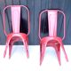 Pair of red stackable metal chairs