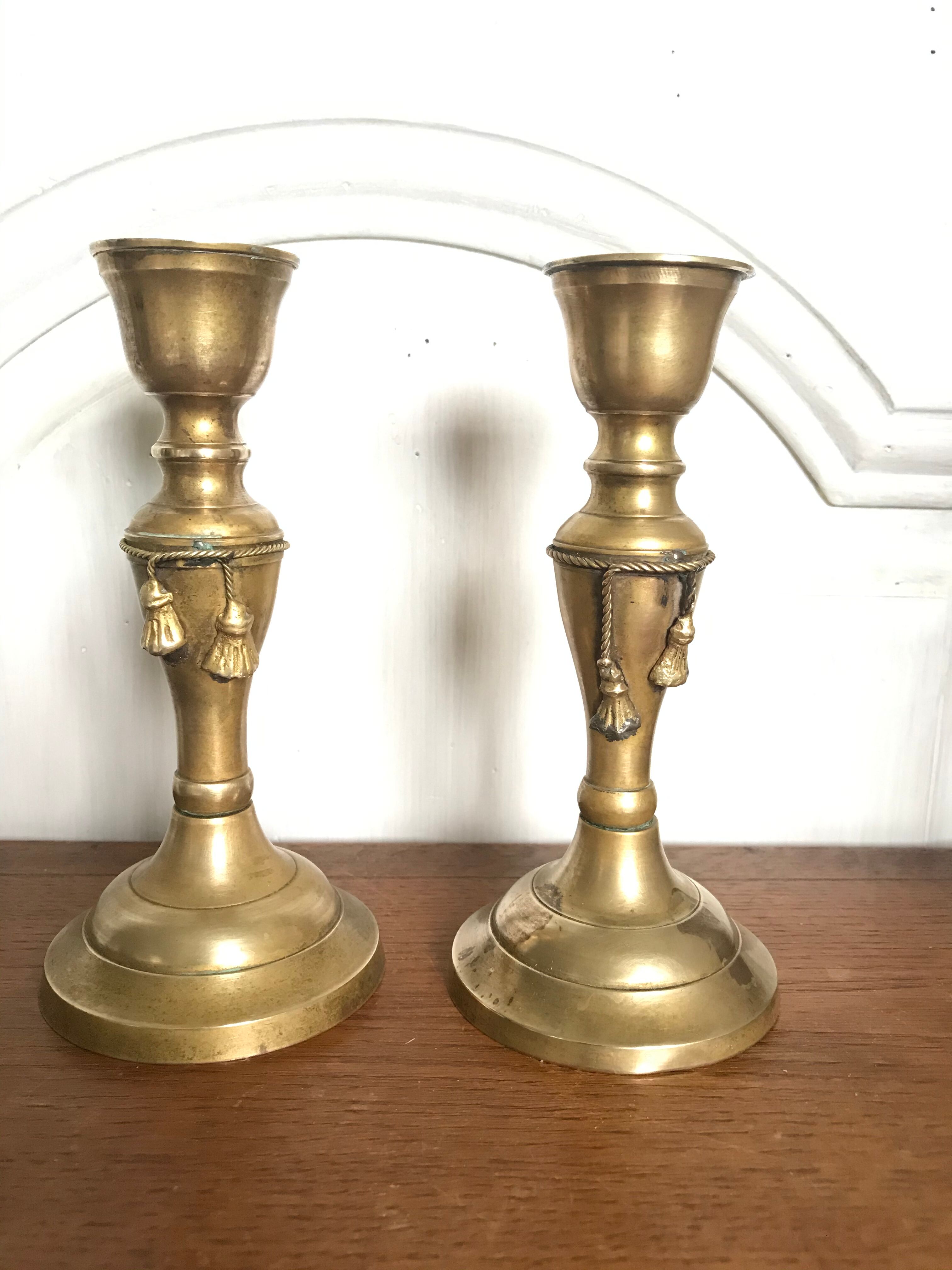 Pair of brass candlesticks with tassels