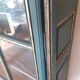 Glass-fronted cabinet in weathered green wood