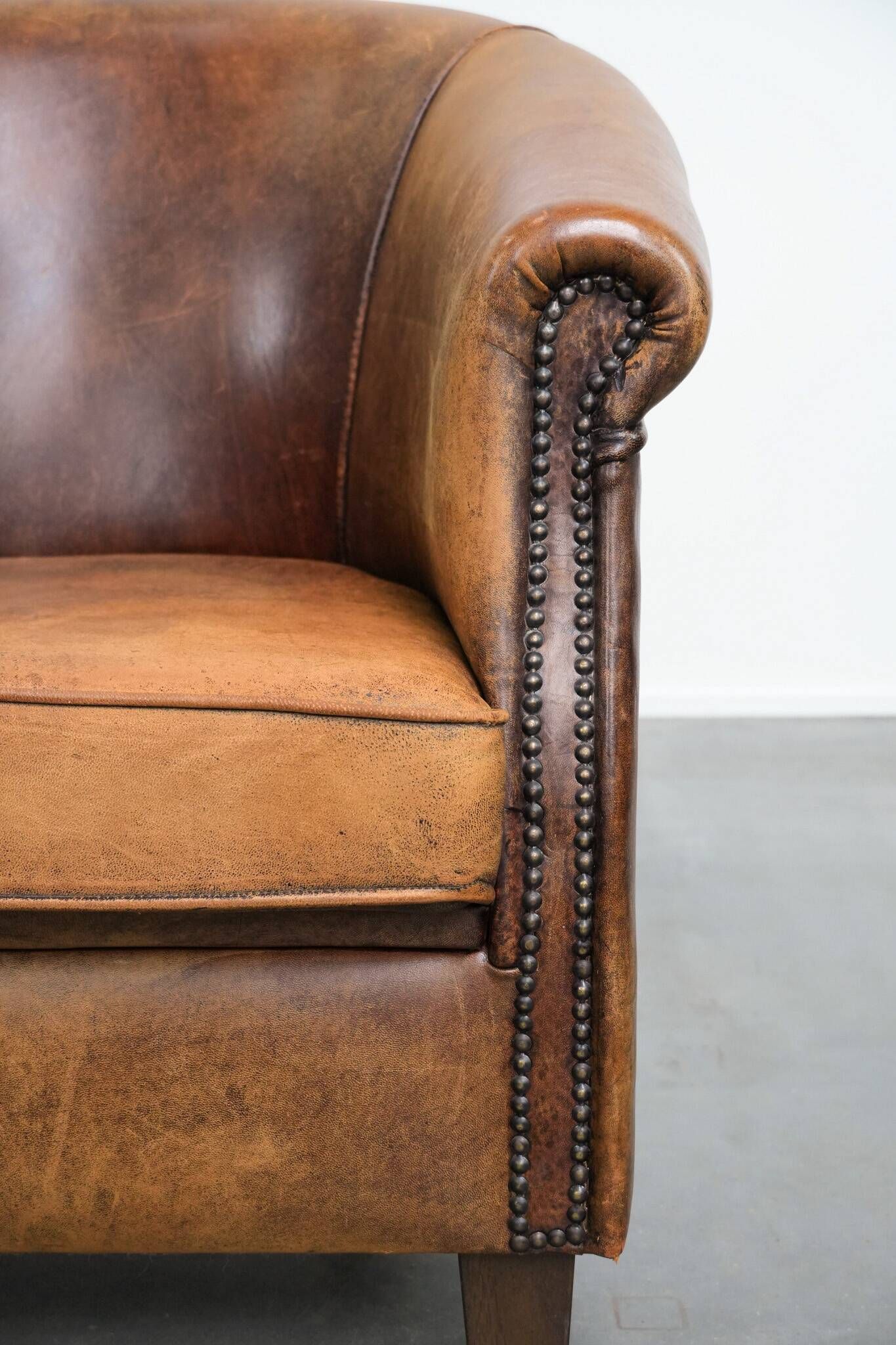 Vintage club chair in sheepskin leather with a characterful look