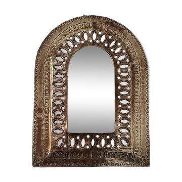 Small golden metal mirror in oriental style.