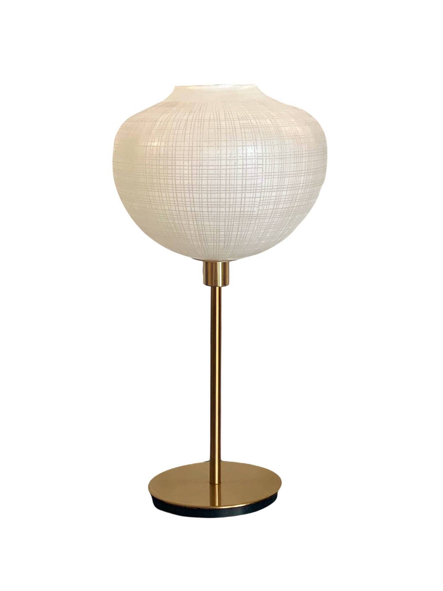Table lamp with a white striped glass globe lampshade and a gold base