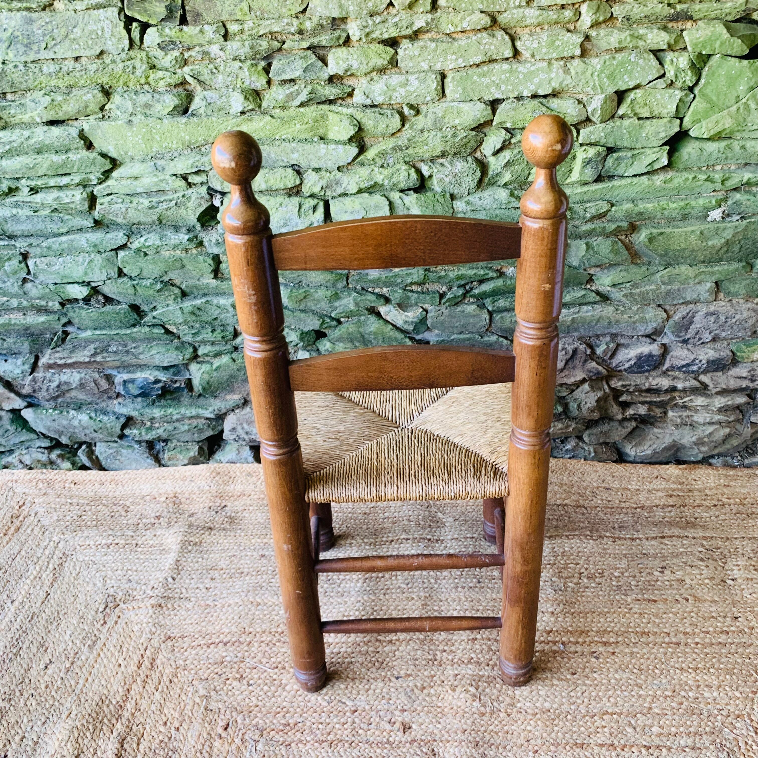 Set of 4 solid wood chairs with straw seats.