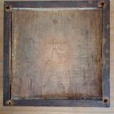 Old table mat made of flt cement tile