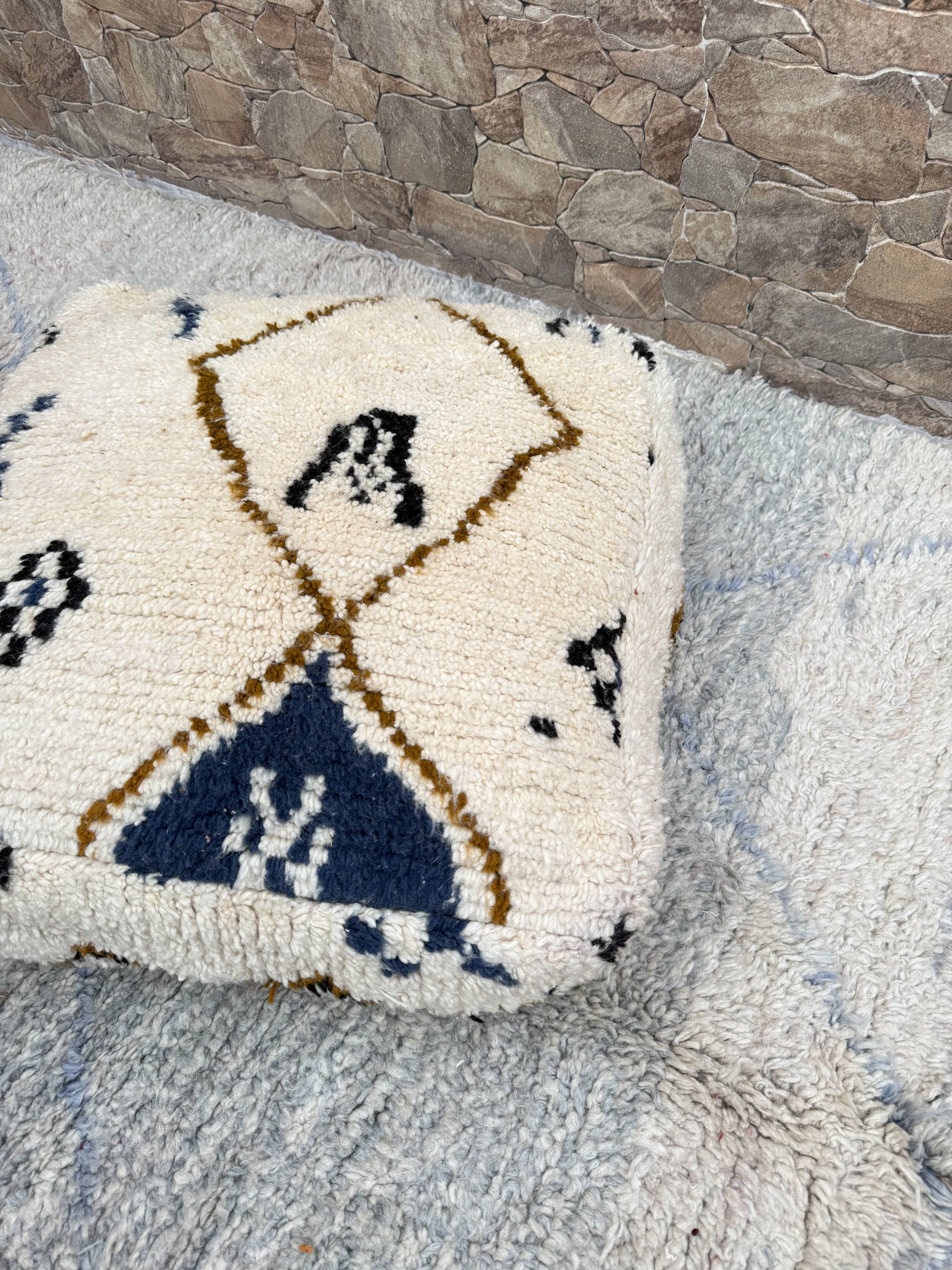 Berber floor pouf: Handwoven Moroccan wool cushion.