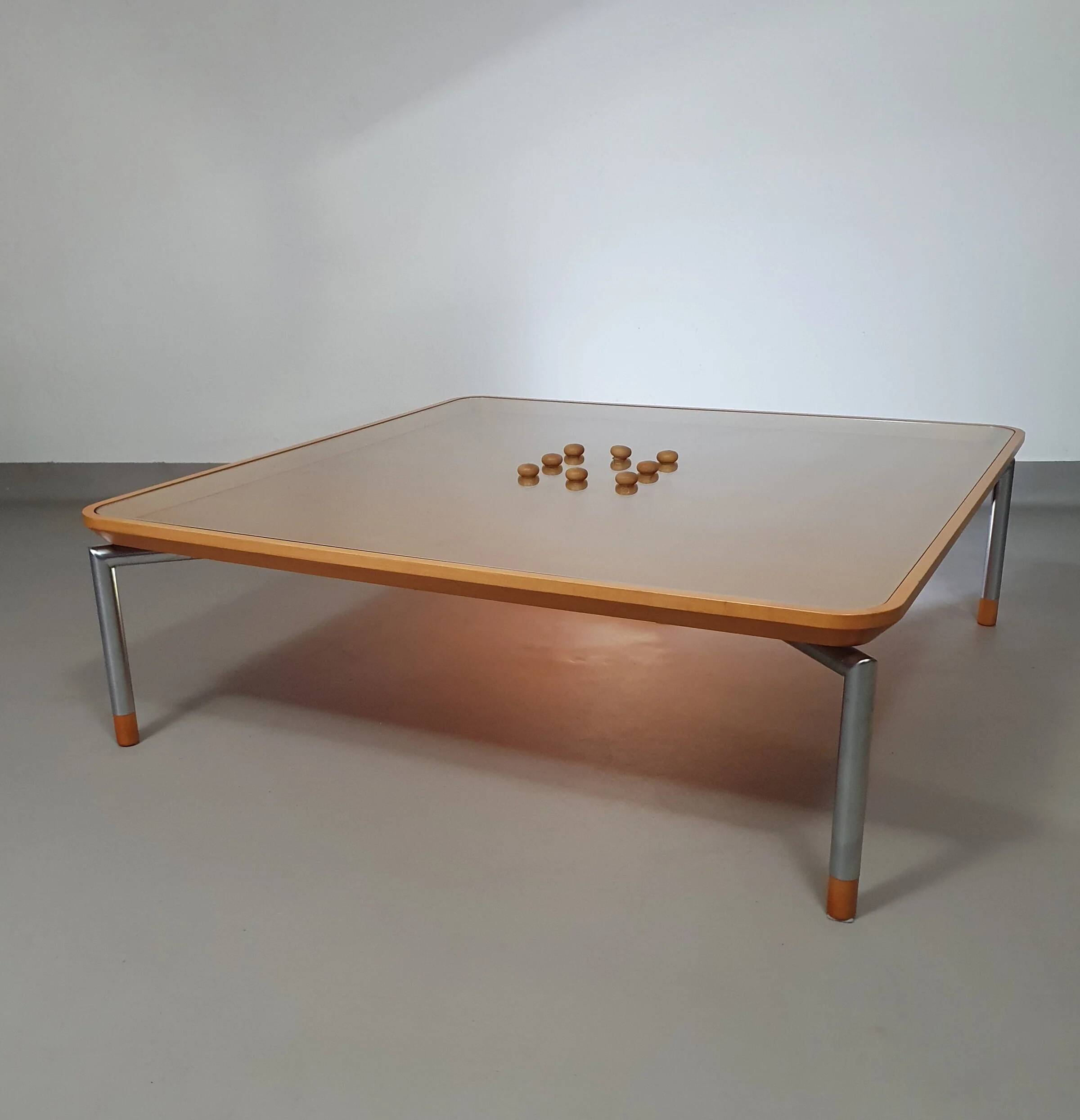 Rare coffee table 110 x 110 x height 35 cm with 8 flange wooden / cork caps in the glass top.