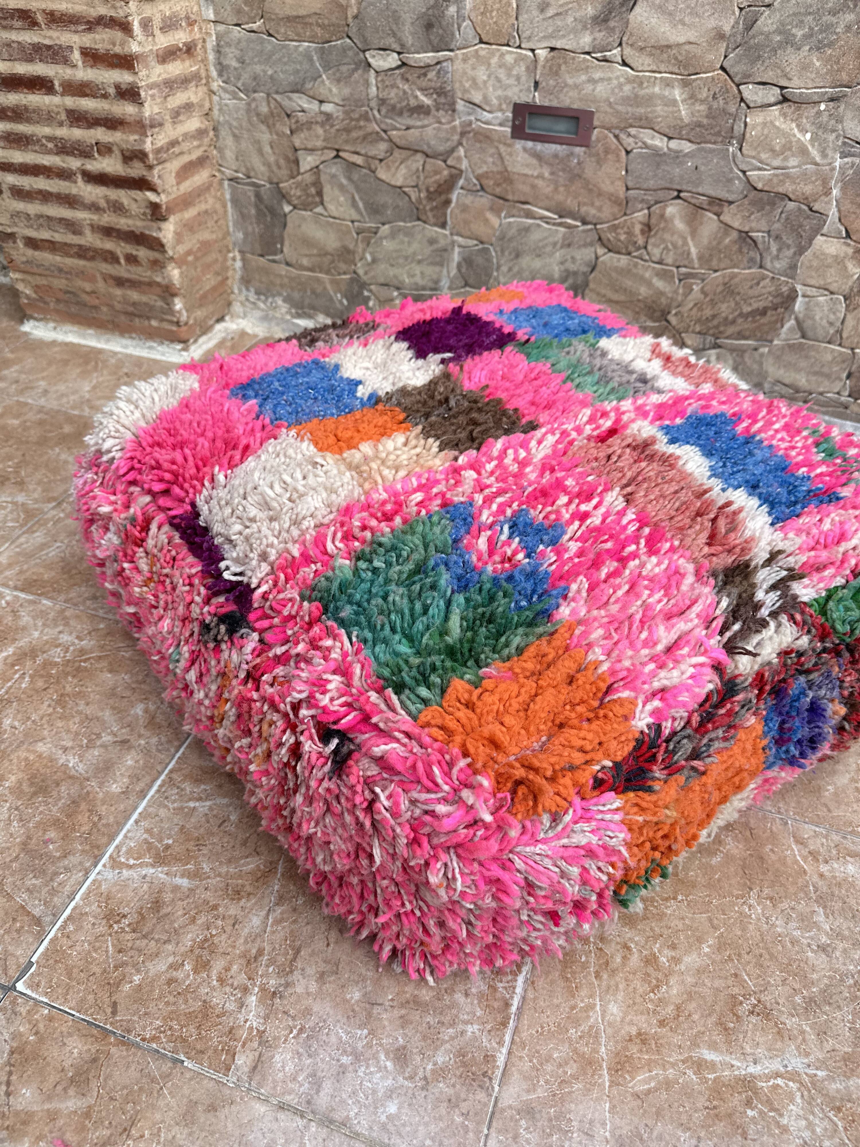 Berber floor pouf: Handwoven Moroccan wool cushion.