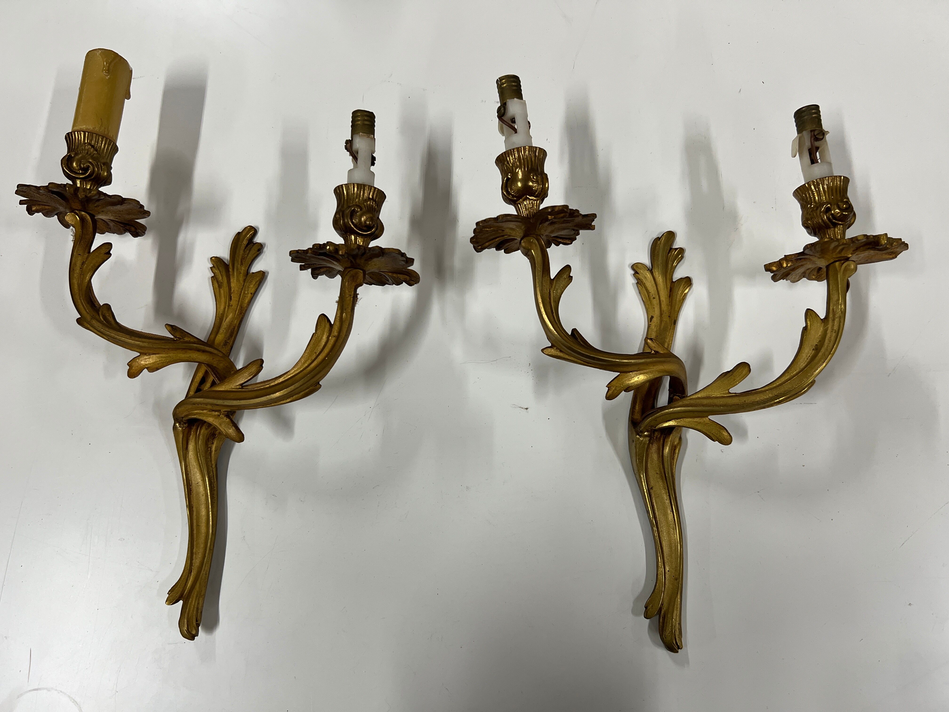 Pair of Louis XV wall lamps in gilded bronze