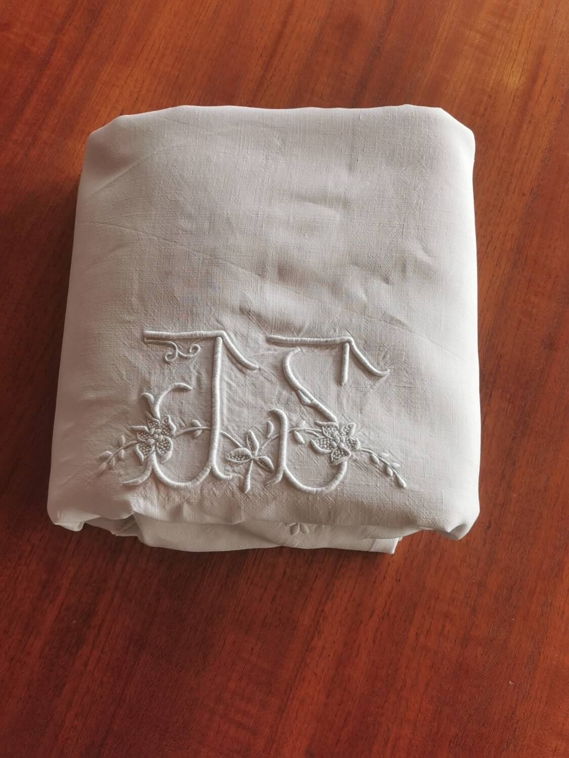 Antique embroidered linen sheet with a monogram.