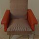 Vintage rockabilly retro armchair in orange faux leather and fabric.
