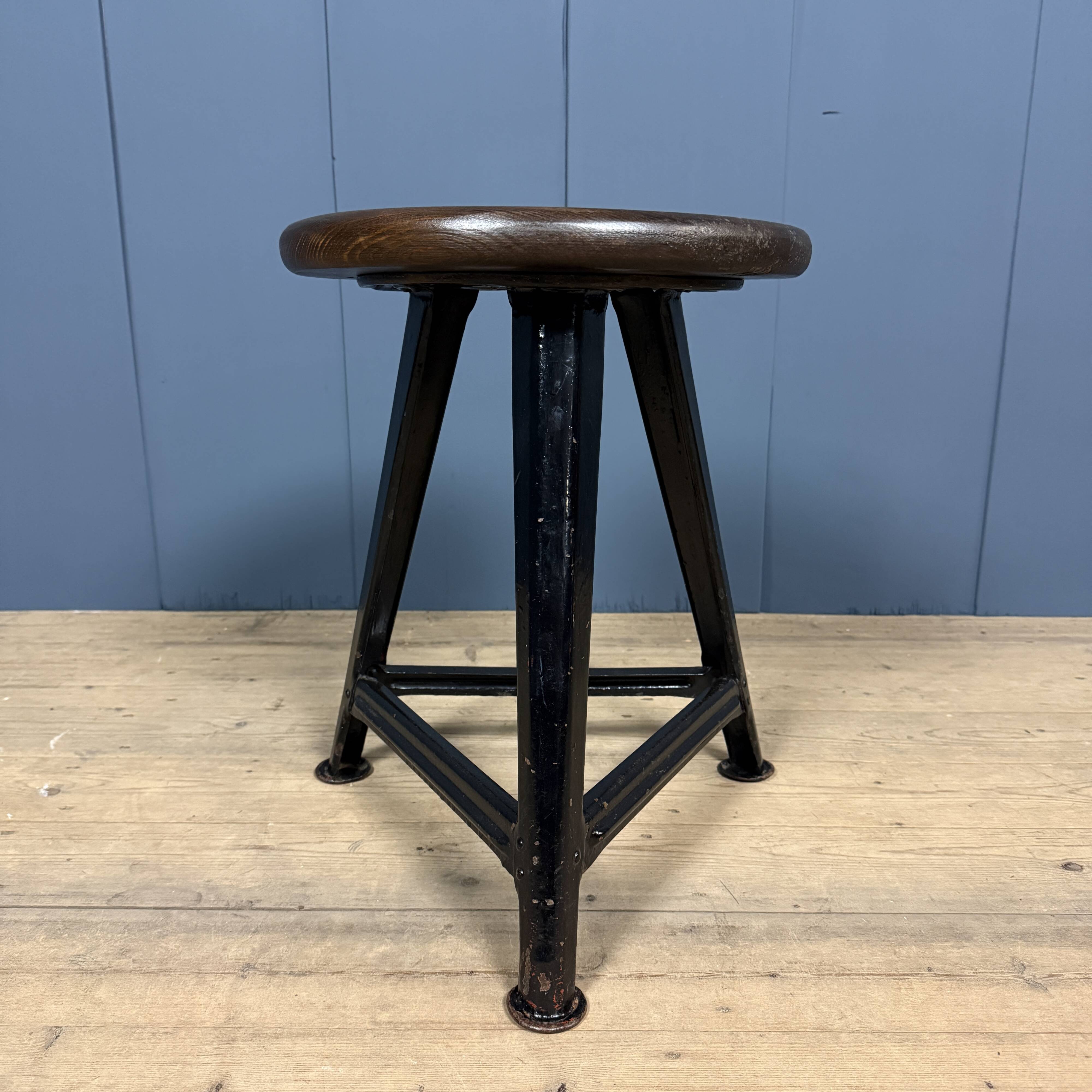 Unmarked black Rowac stool with a dark wood seat.