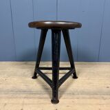 Unmarked black Rowac stool with a dark wood seat.