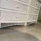 White rattan bedroom set: chest of drawers, mirror, bed, basket